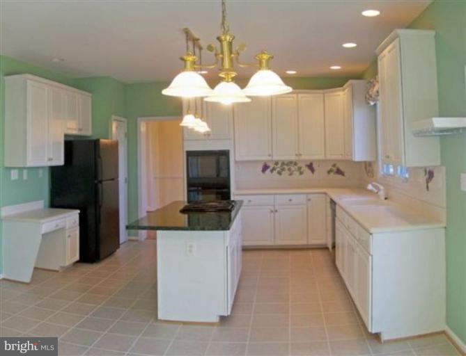 1307 Dasher Lane Reston, VA 20190 - Photo 12 of 29 a large kitchen with a large counter top appliances and cabinets