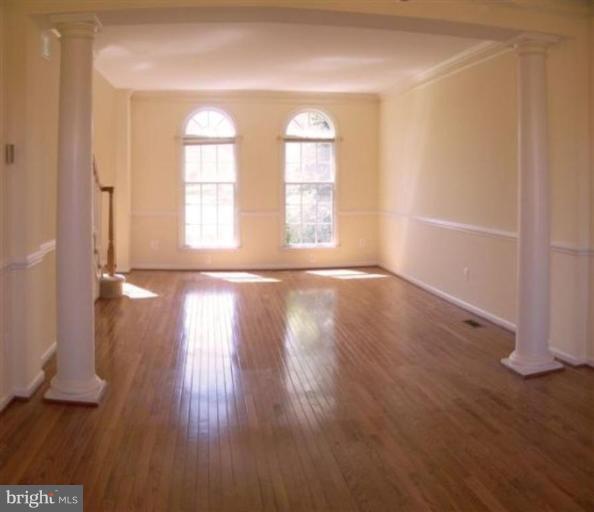 1307 Dasher Lane Reston, VA 20190 - Photo 13 of 29 an empty room with wooden floor and windows