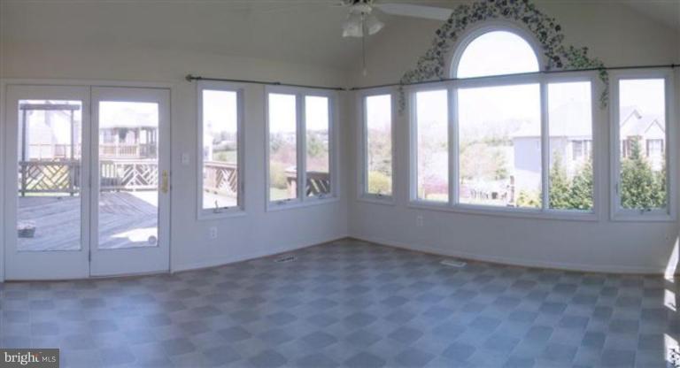 1307 Dasher Lane Reston, VA 20190 - Photo 16 of 29 an empty room with windows and chandelier