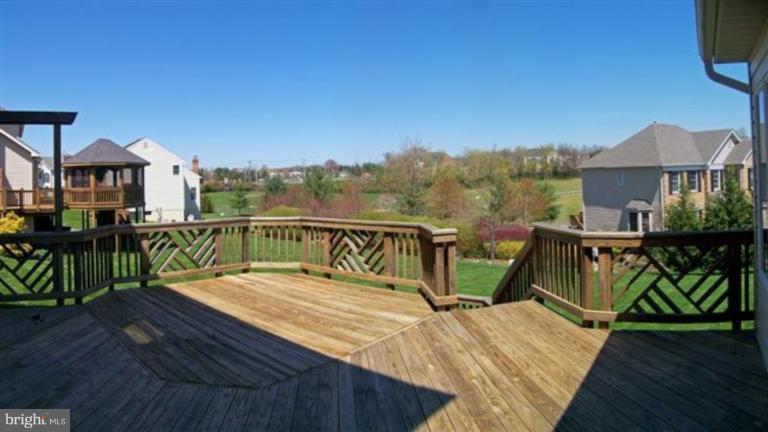 1307 Dasher Lane Reston, VA 20190 - Photo 6 of 29 a view of a roof deck with table and chairs a barbeque with wooden floor and fence