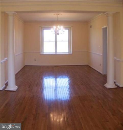 1307 Dasher Lane Reston, VA 20190 - Photo 8 of 29 an empty room with wooden floor and windows