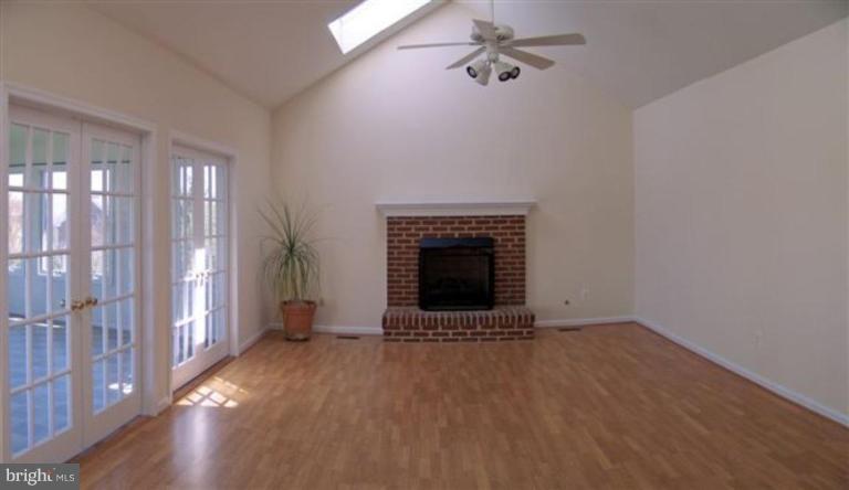 1307 Dasher Lane Reston, VA 20190 - Photo 9 of 29 a view of an empty room with a fireplace and a window