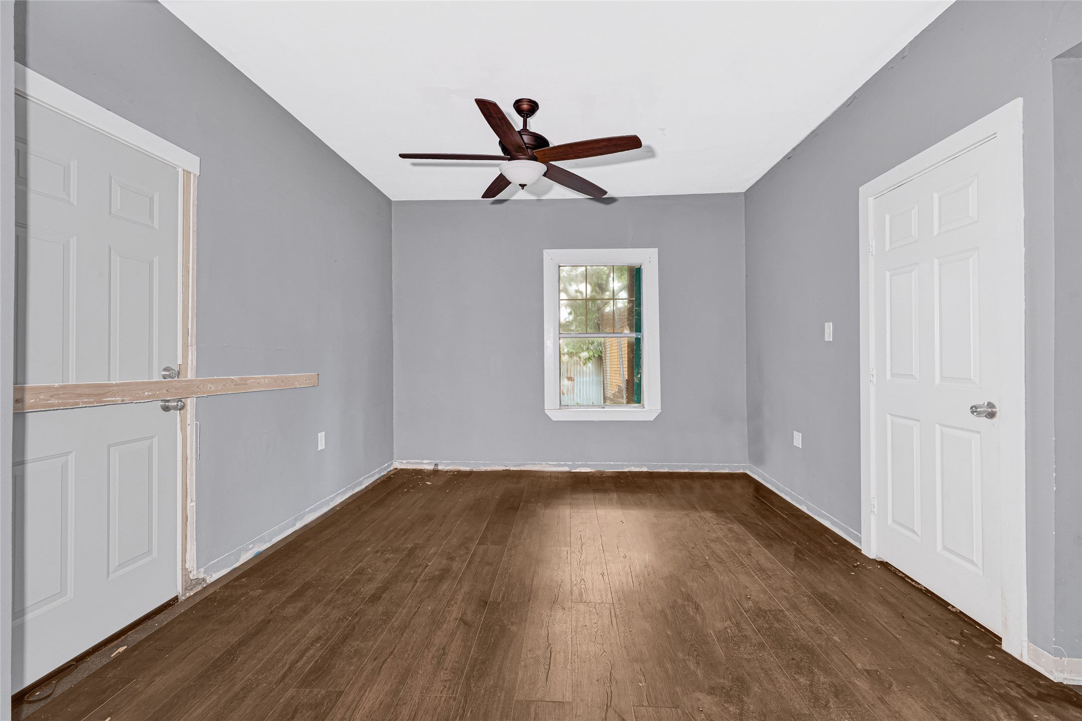 7305 Tremper Street Houston, TX 77020 - Photo 11 of 28 wooden floor in an empty room with a window