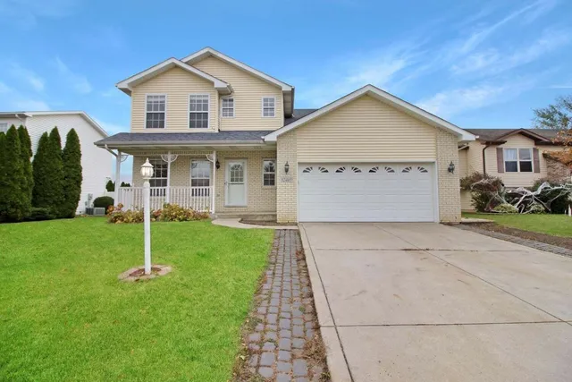 a view of a house with a yard and pathway