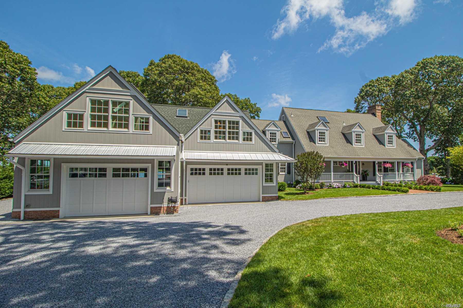 3855 Noyack Road Sag Harbor, NY 11963 - Photo 1 of 1 a front view of a house with a yard and potted plants