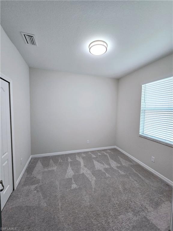 Undisclosed Address Naples, FL 34120 - Photo 11 of 21 an empty room with a window