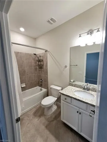 a bathroom with a sink a toilet a mirror a bathtub and shower