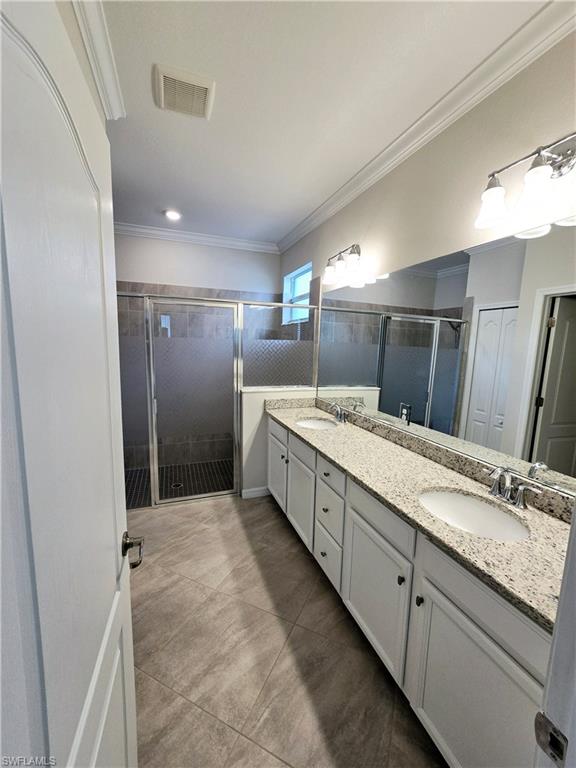 Undisclosed Address Naples, FL 34120 - Photo 16 of 21 a large bathroom with a sink and a large mirror