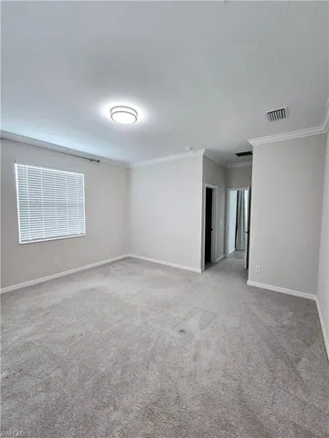 an empty room with a empty space and windows