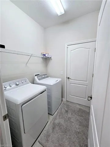 a view of storage and utility room with washer and dryer