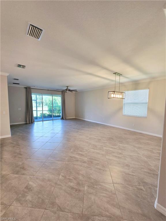 Undisclosed Address Naples, FL 34120 - Photo 5 of 21 an empty room with wooden floor and natural light
