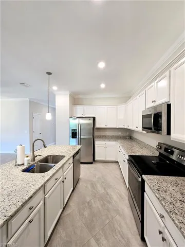 a kitchen with stainless steel appliances granite countertop a sink stove and cabinets