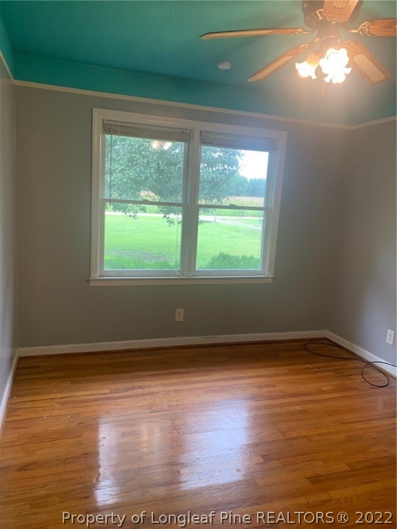 68 Flowers Settlemeyer Road Riegelwood, NC 28456 - Photo 14 of 28 a view of an empty room with wooden floor and a window