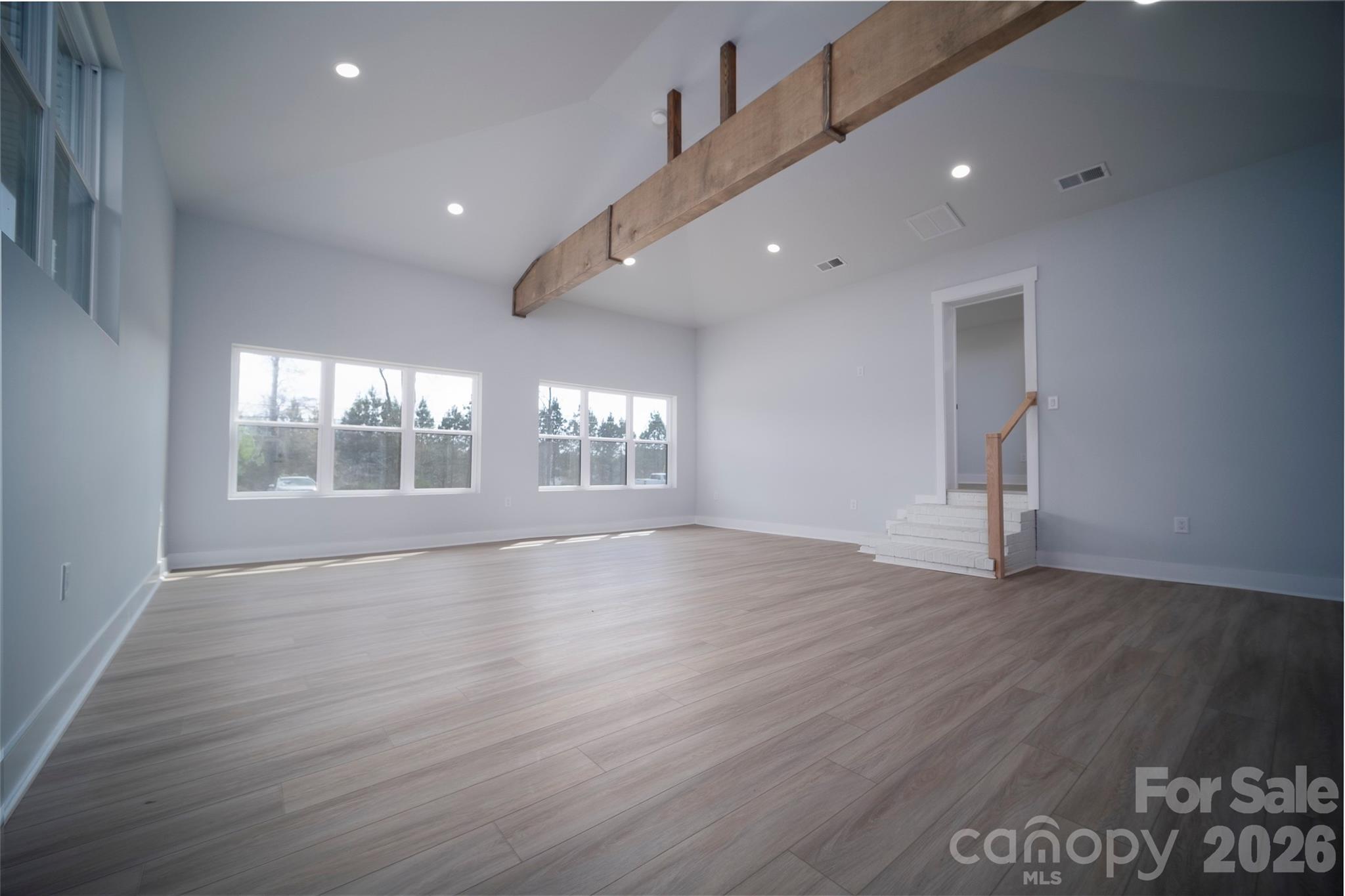 1325 Armstrong Road Belmont, NC 28012 - Photo 14 of 33 a view of an empty room with wooden floor and a window