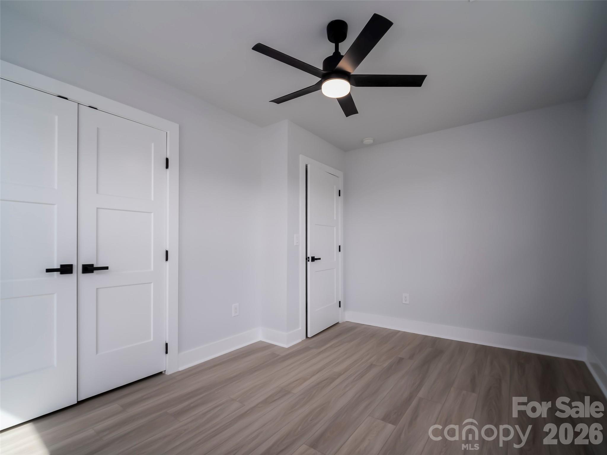 1325 Armstrong Road Belmont, NC 28012 - Photo 18 of 33 an empty room with wooden floor and a ceiling fan