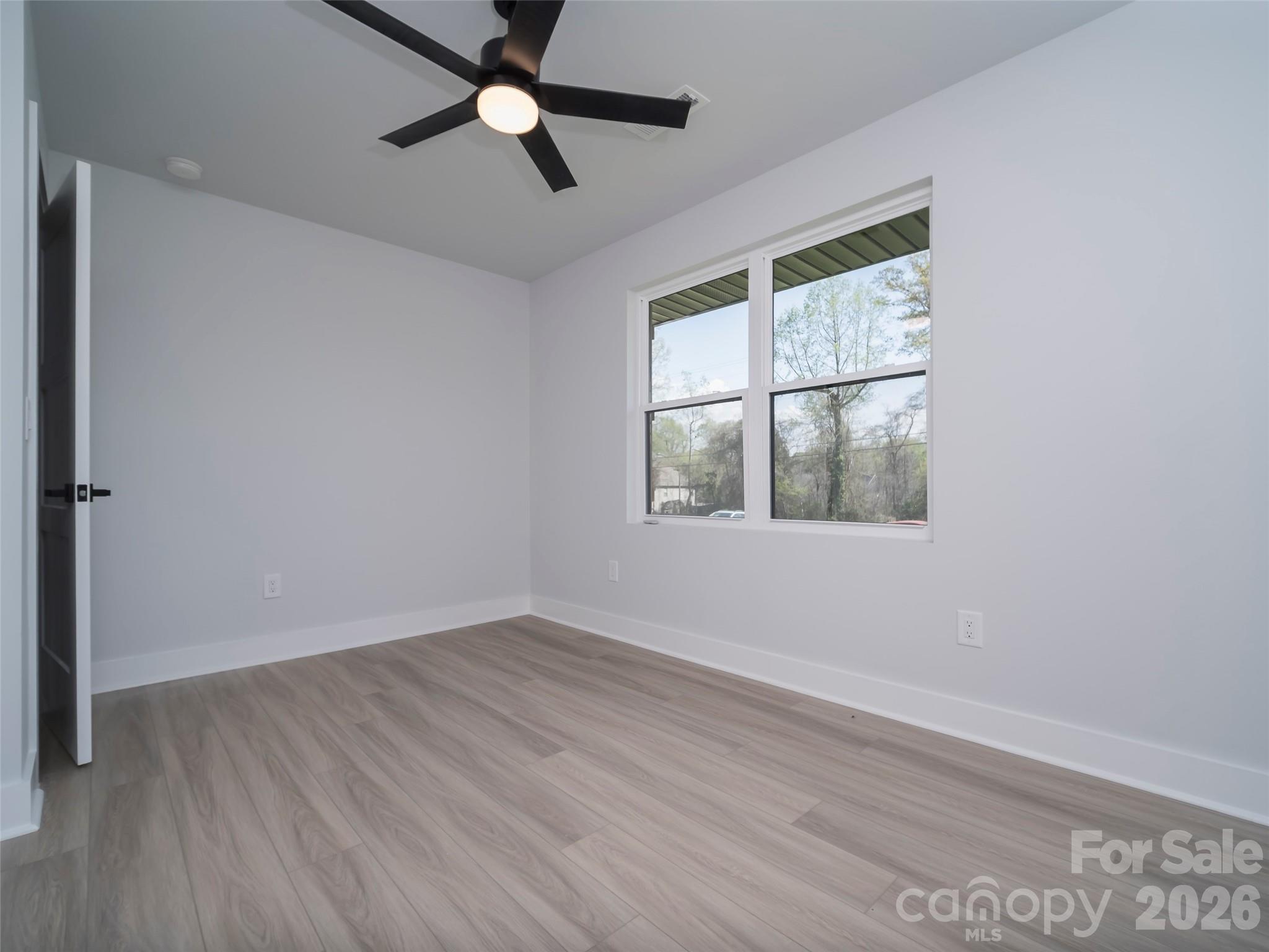 1325 Armstrong Road Belmont, NC 28012 - Photo 19 of 33 an empty room with wooden floor fan and windows