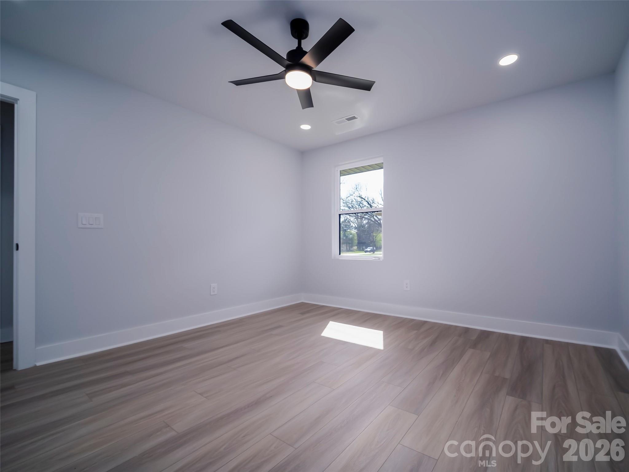 1325 Armstrong Road Belmont, NC 28012 - Photo 22 of 33 an empty room with wooden floor and windows