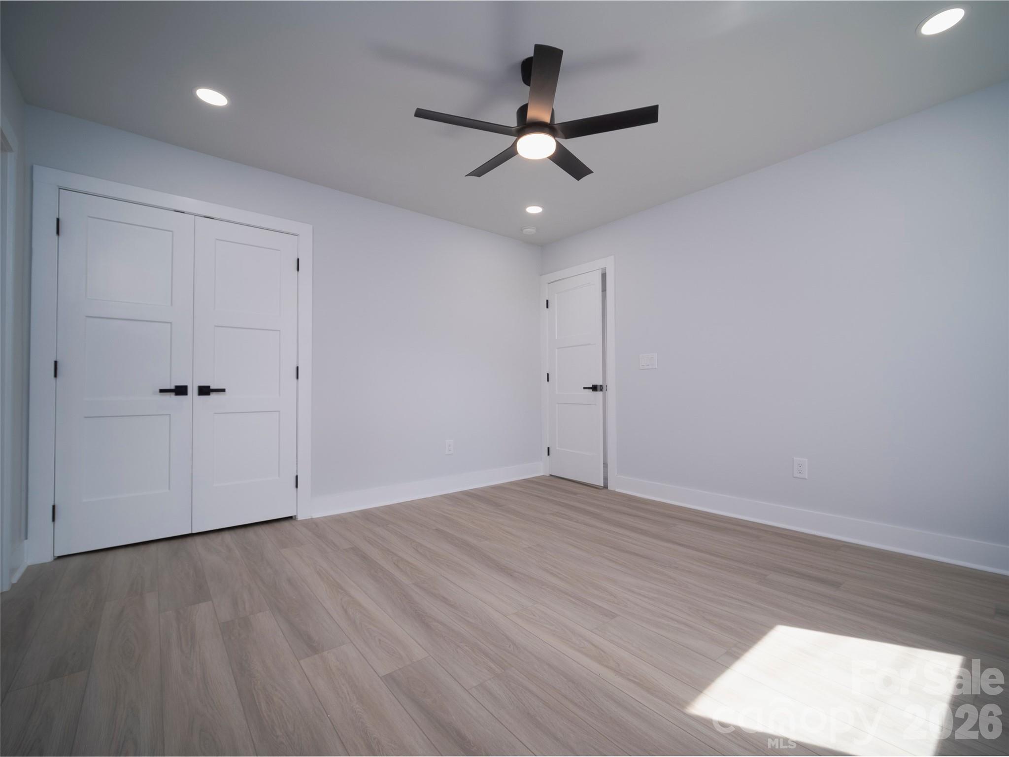 1325 Armstrong Road Belmont, NC 28012 - Photo 25 of 33 an empty room with a ceiling fan and wooden floor