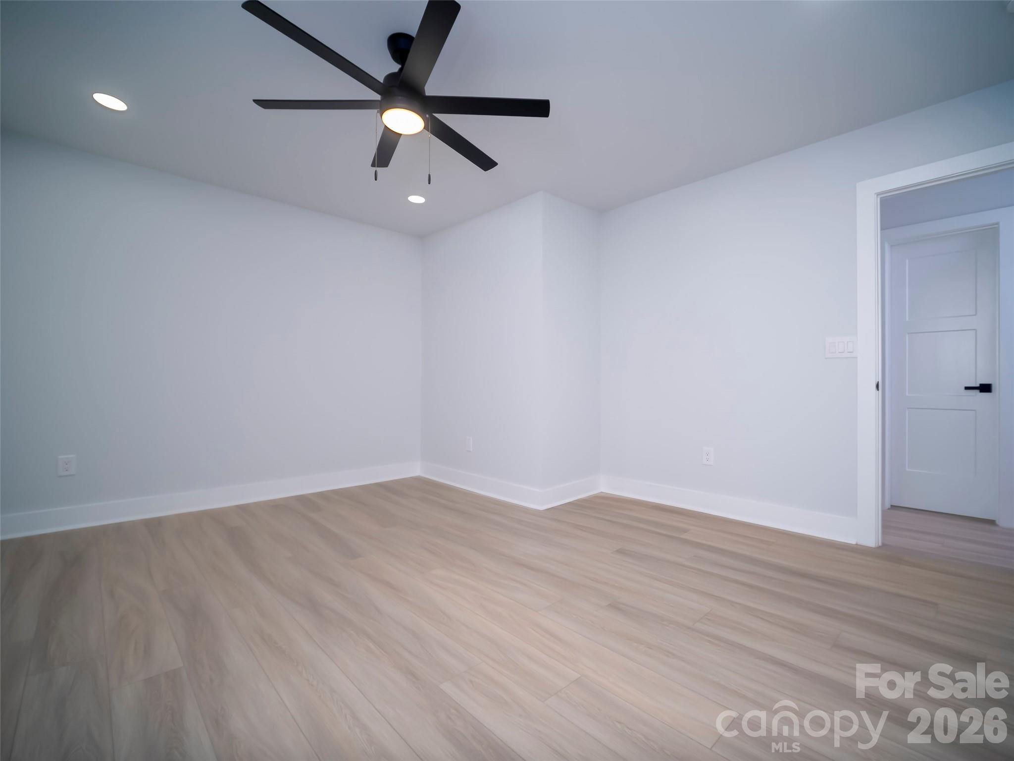 1325 Armstrong Road Belmont, NC 28012 - Photo 28 of 33 an empty room with wooden floor and a ceiling fan