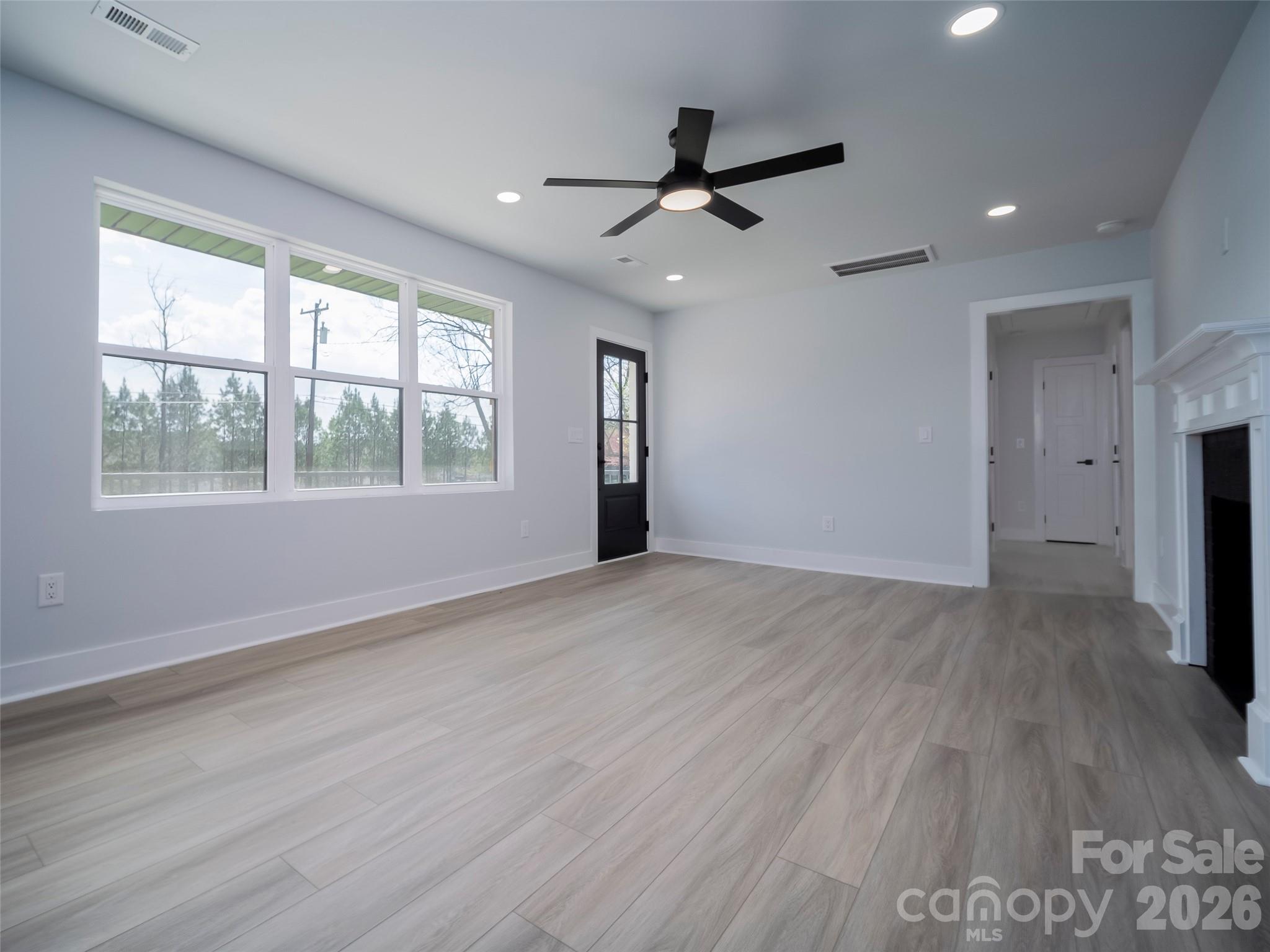 1325 Armstrong Road Belmont, NC 28012 - Photo 4 of 33 a view of an empty room with a window and wooden floor