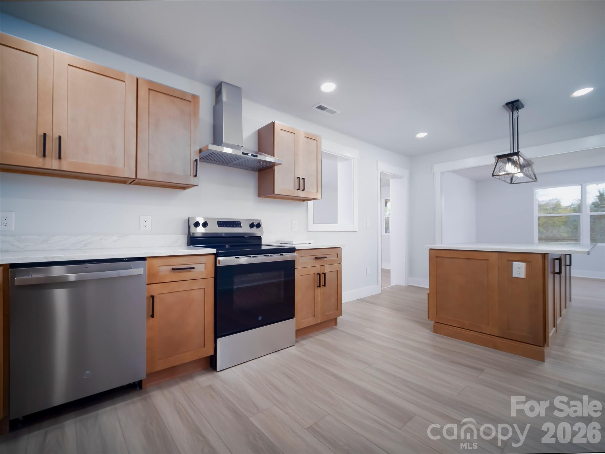 1325 Armstrong Road Belmont, NC 28012 - Photo 5 of 33 a kitchen with stainless steel appliances granite countertop a stove a sink dishwasher and a refrigerator with wooden floor