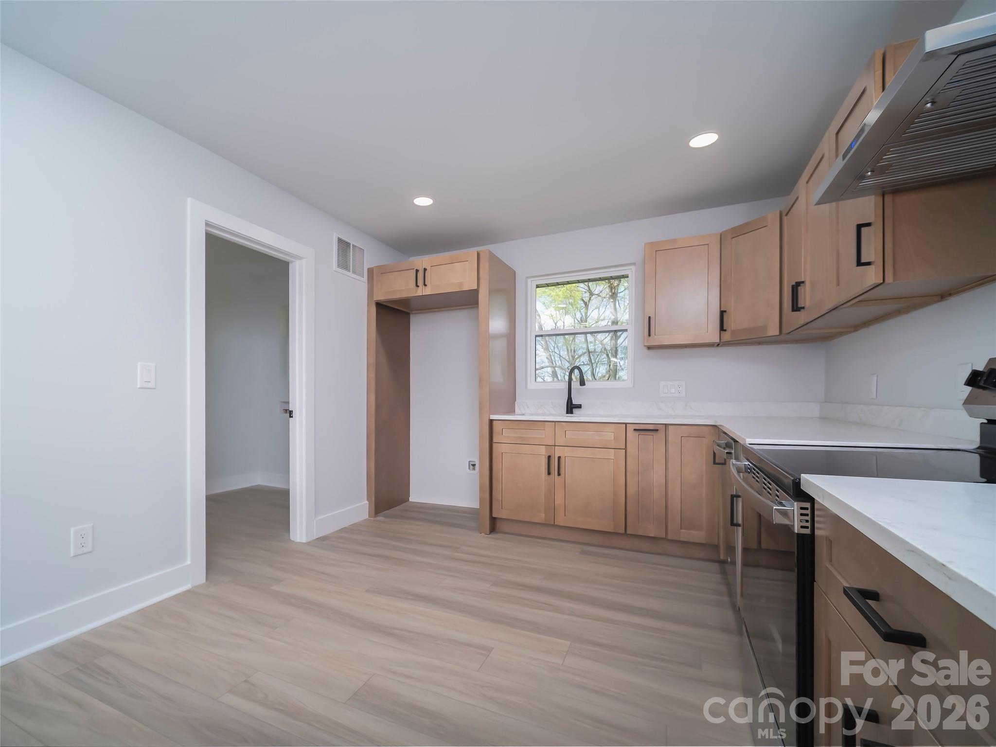 1325 Armstrong Road Belmont, NC 28012 - Photo 8 of 33 a kitchen with sink cabinets and wooden floor