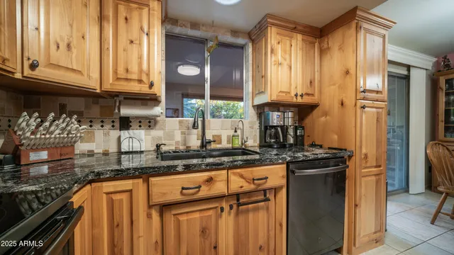 a kitchen with stainless steel appliances granite countertop a stove and a refrigerator