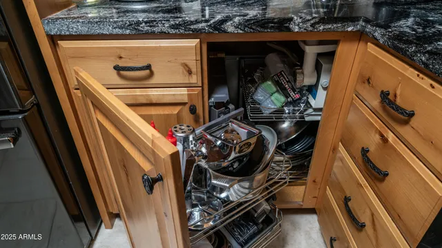 a kitchen with granite countertop a sink and a stove