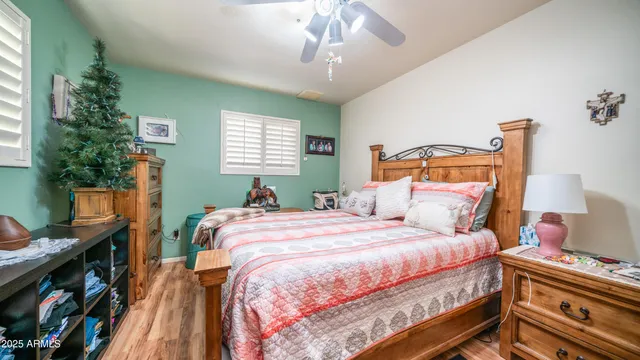 a bedroom with a bed and a chandelier