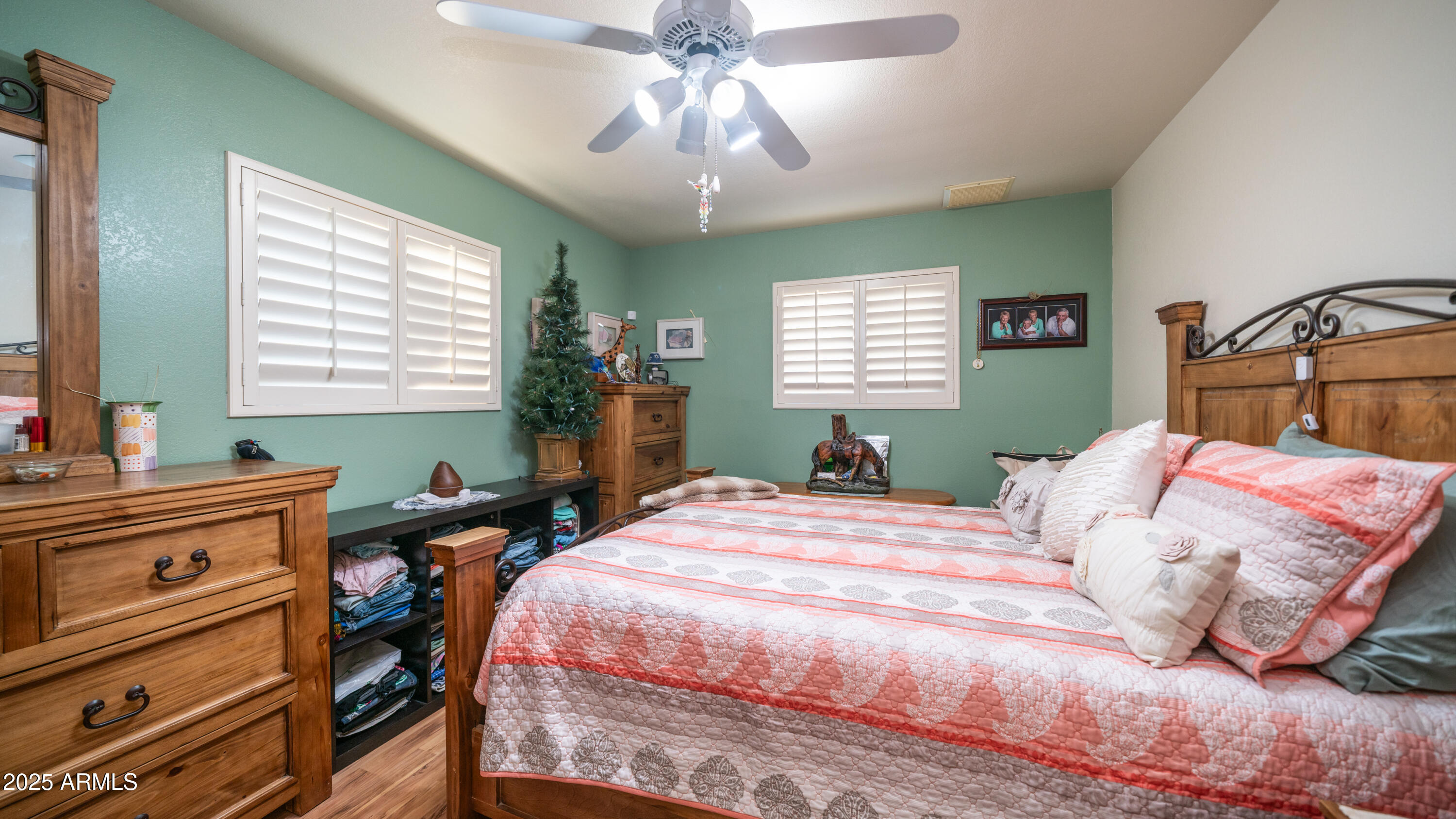657 South Copper Drive Apache Junction, AZ 85120 - Photo 18 of 44 a bedroom with a bed and a chandelier