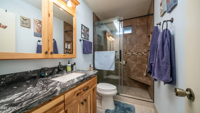 a bedroom with a bed and a flat tv screen on dresser