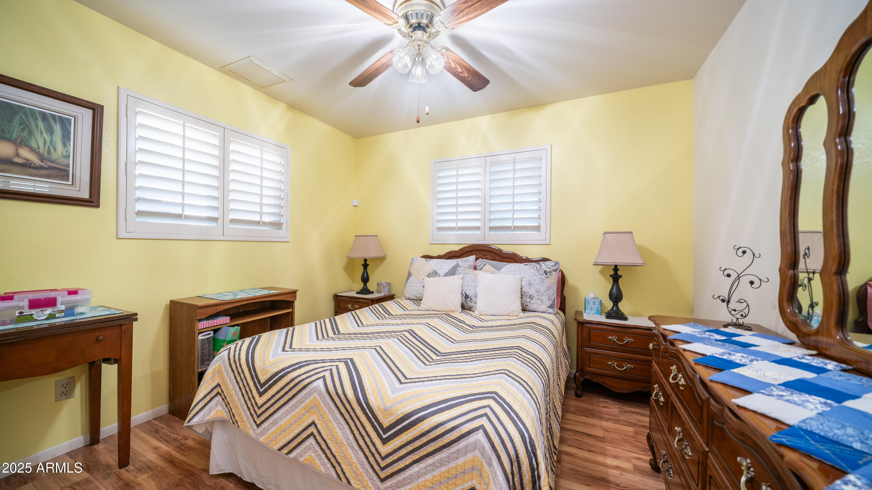 657 South Copper Drive Apache Junction, AZ 85120 - Photo 20 of 44 a bedroom with a bed and a flat tv screen on dresser