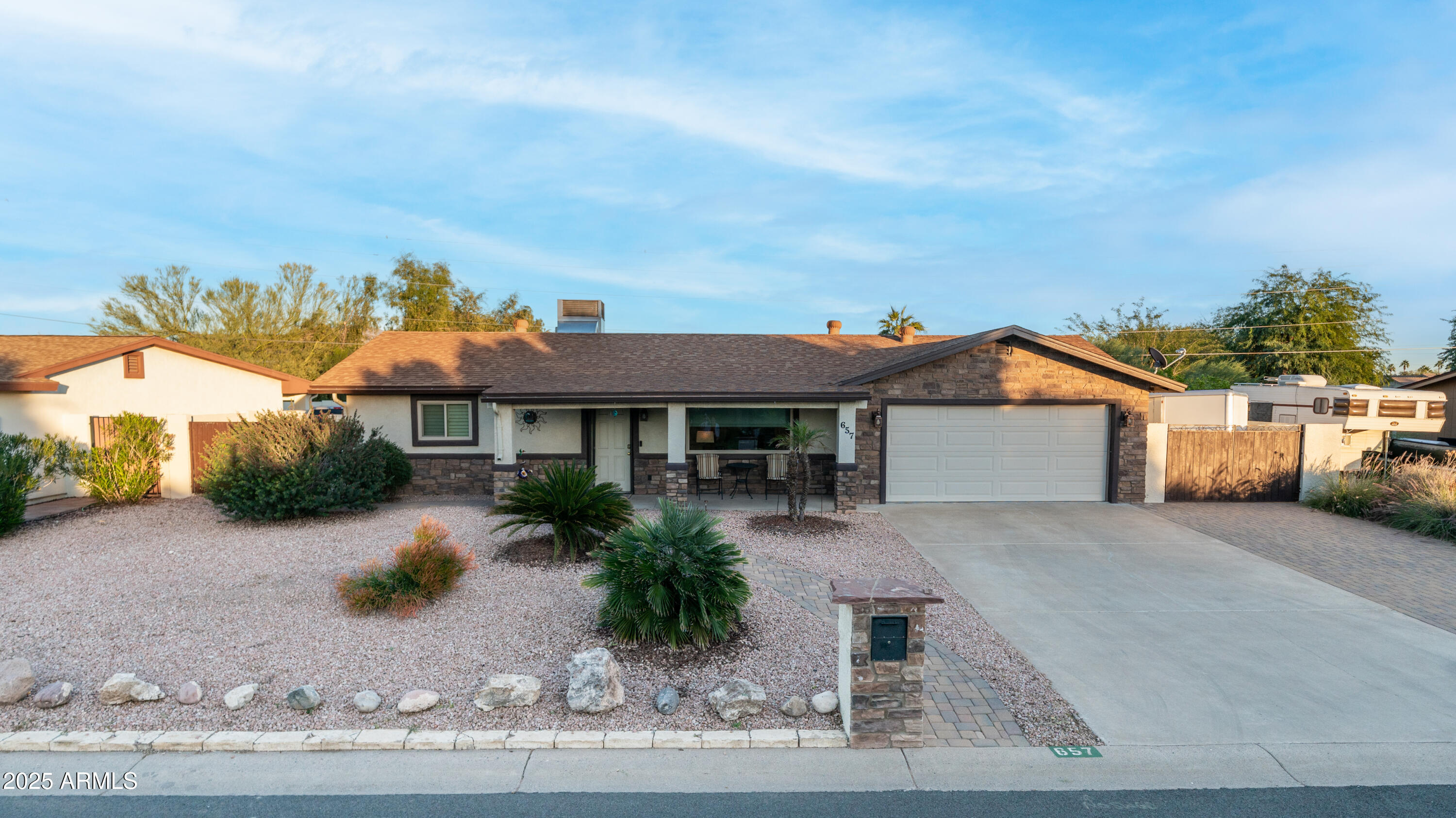 657 South Copper Drive Apache Junction, AZ 85120 - Photo 3 of 44 a front view of a house with a yard and garage