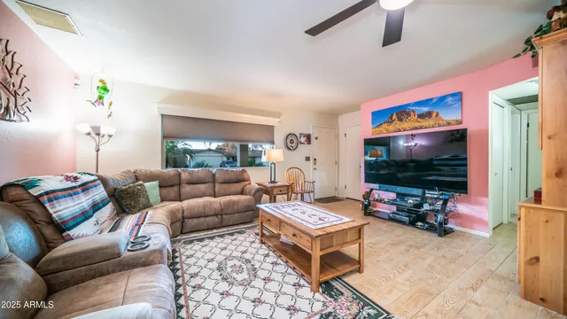 a living room with furniture and a wooden floor