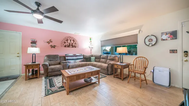 a living room with furniture and wooden floor