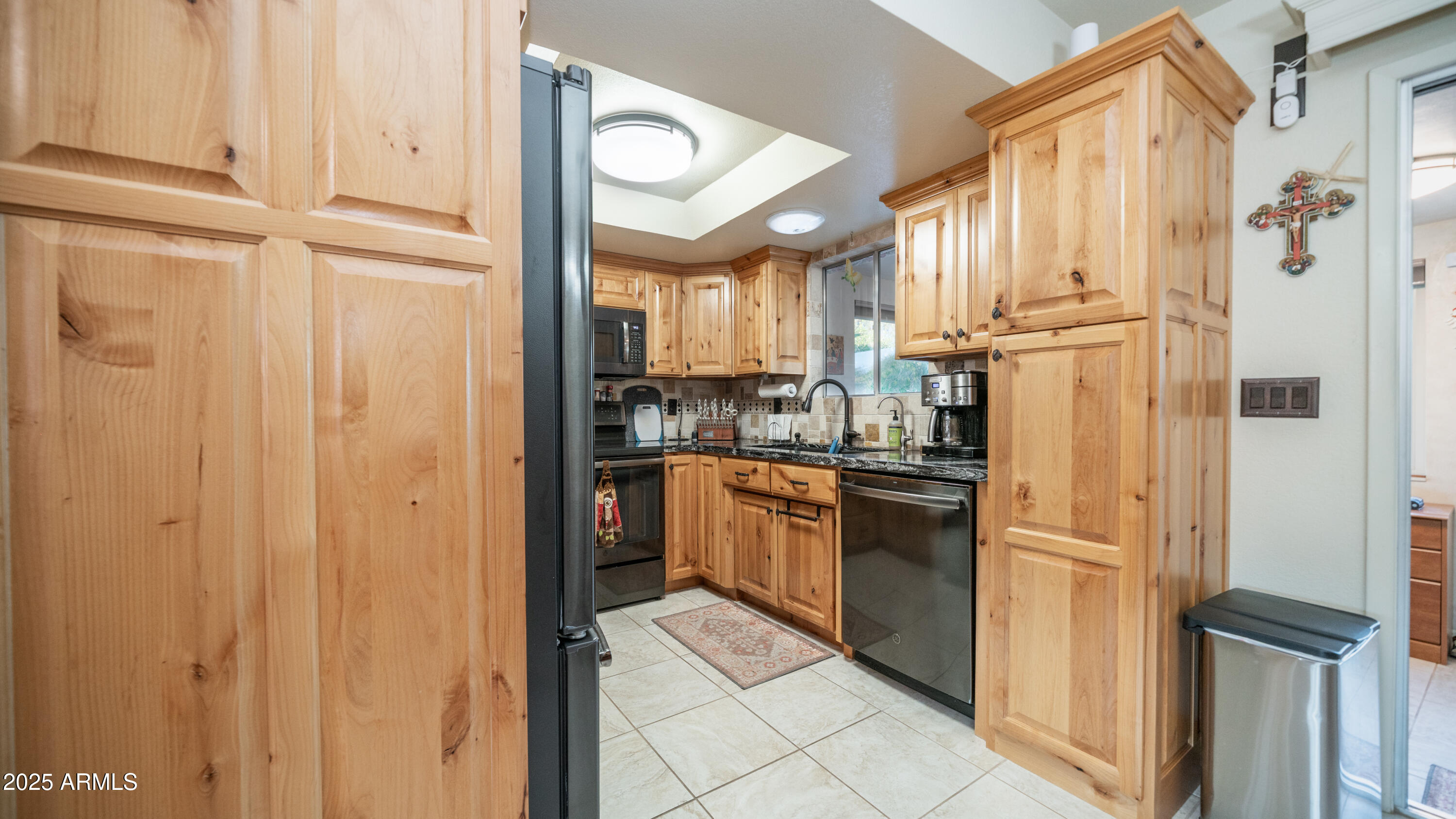 657 South Copper Drive Apache Junction, AZ 85120 - Photo 9 of 44 a kitchen with stainless steel appliances granite countertop a refrigerator and a sink