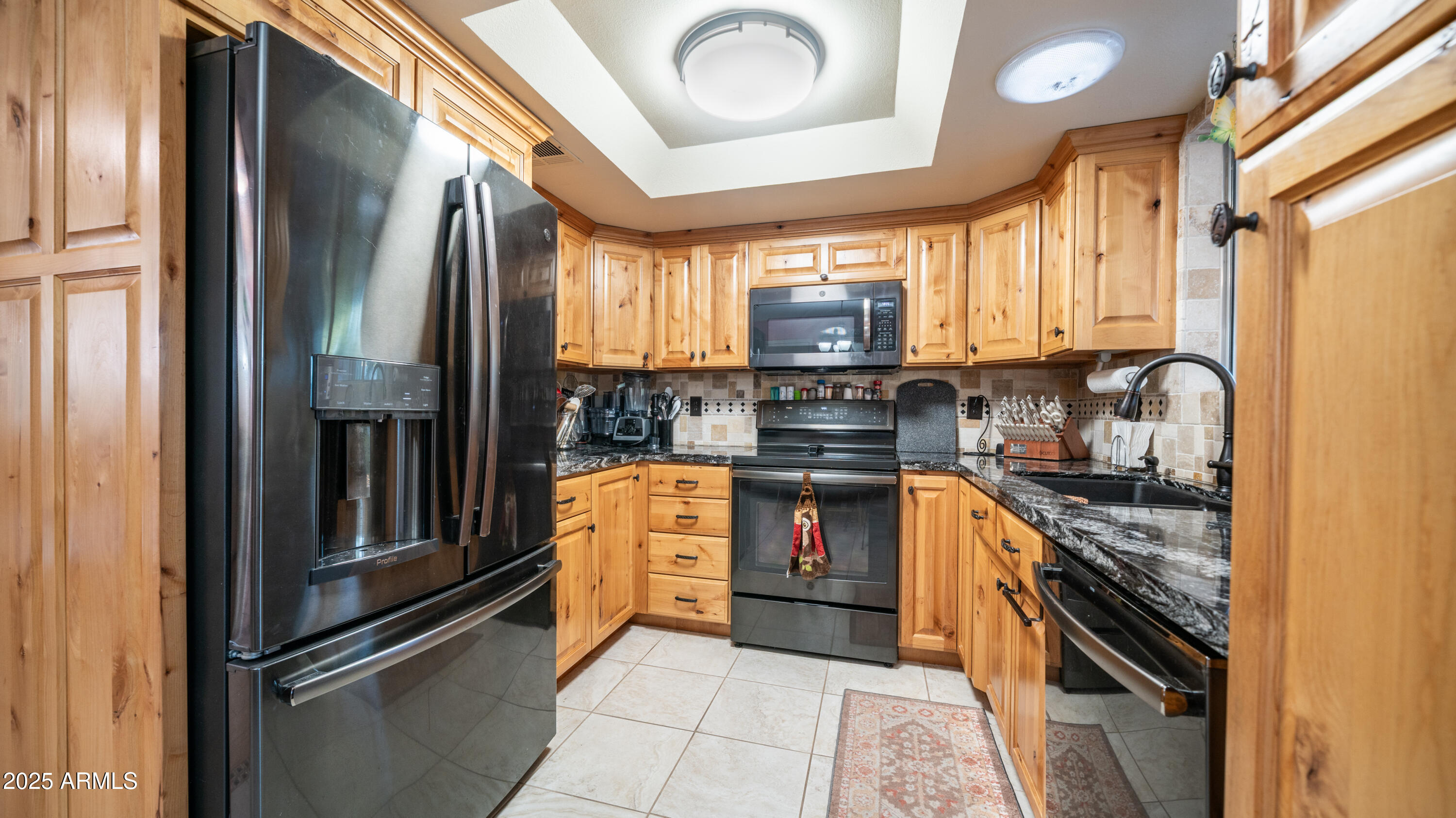 657 South Copper Drive Apache Junction, AZ 85120 - Photo 10 of 44 a kitchen with stainless steel appliances granite countertop a refrigerator a stove and a sink
