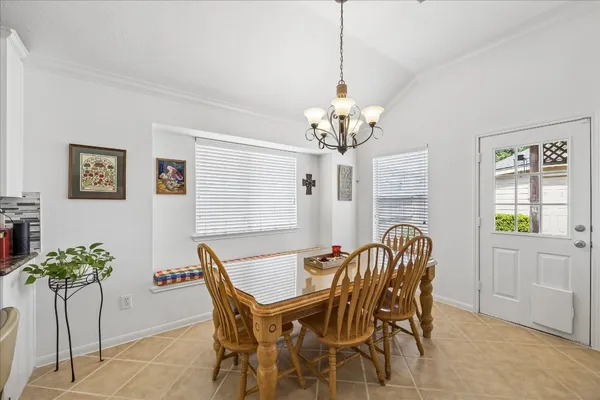 a view of a dining room with furniture and window