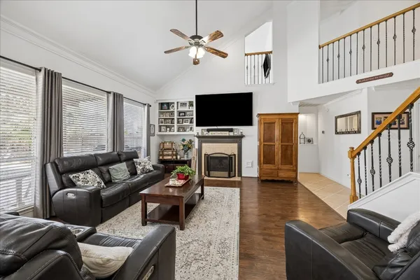 a living room with furniture a flat screen tv and a fireplace