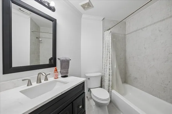 a bathroom with a sink toilet vanity and shower