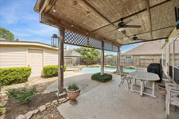 a view of a patio with a table and chairs and potted plants