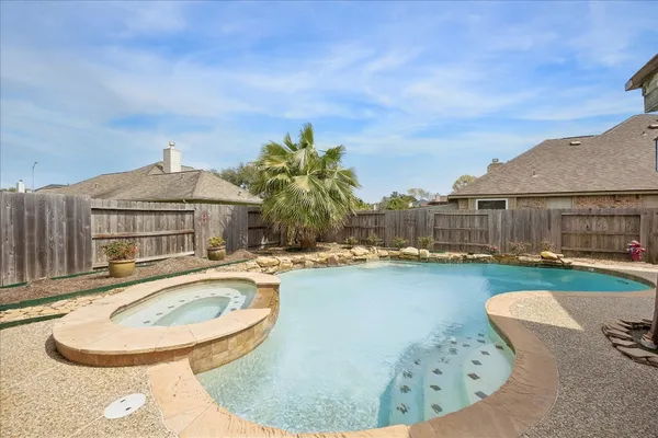 a swimming pool with outdoor seating and yard