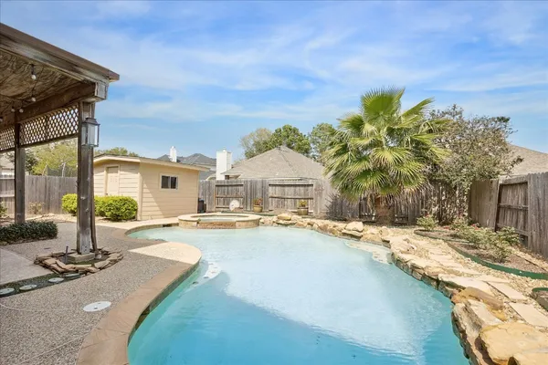 a view of a house with swimming pool and sitting area
