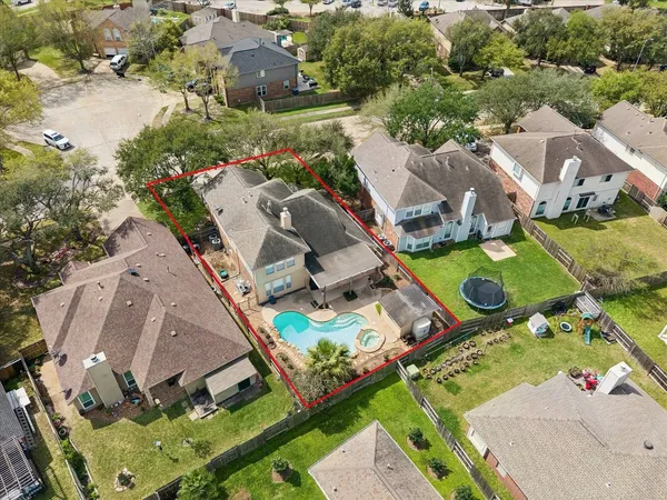 an aerial view of a house with a garden and lake view