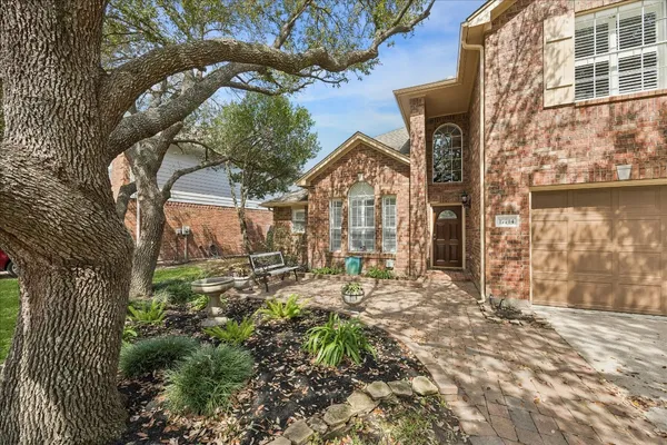 a view of a house with a tree in the background