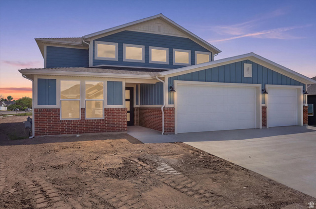 Contemporary two-story residence featuring brick and blue siding exterior