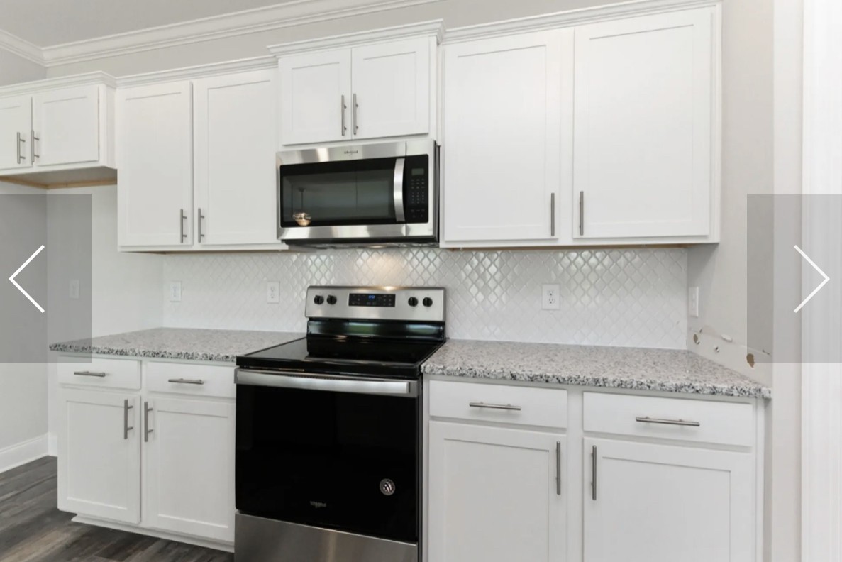 7132 Pepper Tree Circle Fairview, TN 37062 - Photo 4 of 14 a kitchen with white cabinets and black appliances
