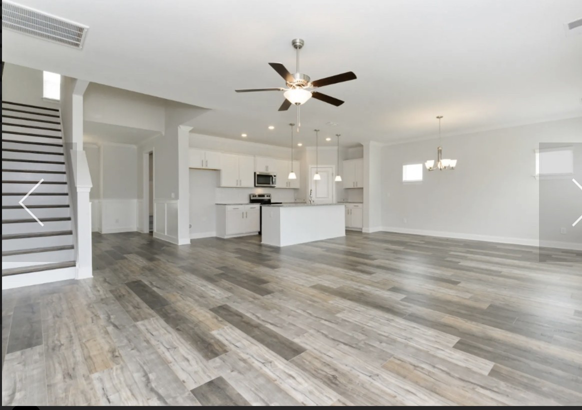 7132 Pepper Tree Circle Fairview, TN 37062 - Photo 5 of 14 an empty space with kitchen view and wooden floor