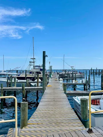 a view of a balcony with wooden floor and seating