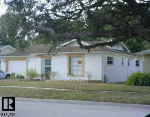 11525 Nature Trail Port Richey, FL 34668 - Photo 1 of 1 front view of house with a yard